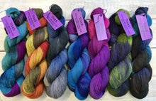 Load image into Gallery viewer, Touch Yarns Hand-Painted Possum Silk Merino 2ply in shades of (left to right) Macaw (pink, purple, teal, green), Kea (orange, peach, pale and forest greens), Kingfisher (shades of blue including navy, royal and sky, and grey), Peacock (deep royal blue, pale blue, lilac blue and purple), Flamingo (pink and shades of purple), Kakapo (pale grass green, deep navy and blues) and Bluebird (charcoal, range of blues from dark navy to sky - Cast On a Few Yarns & Supplies