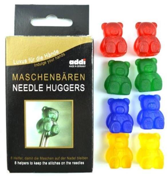 Packaging box on left; eight 3-D bear-shaped needle huggers, two each of orange, green, blue and yellow. Each colour has different size hole in bottom.